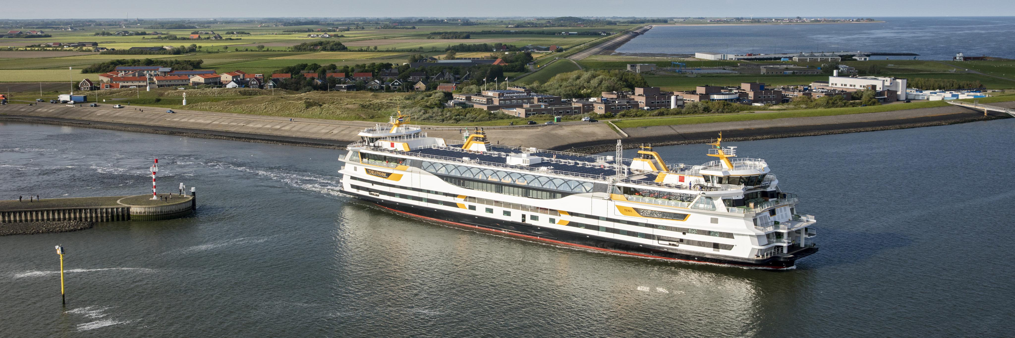 Ferry boat leaving the harbour on Texel with the NIOZ buildings in the background